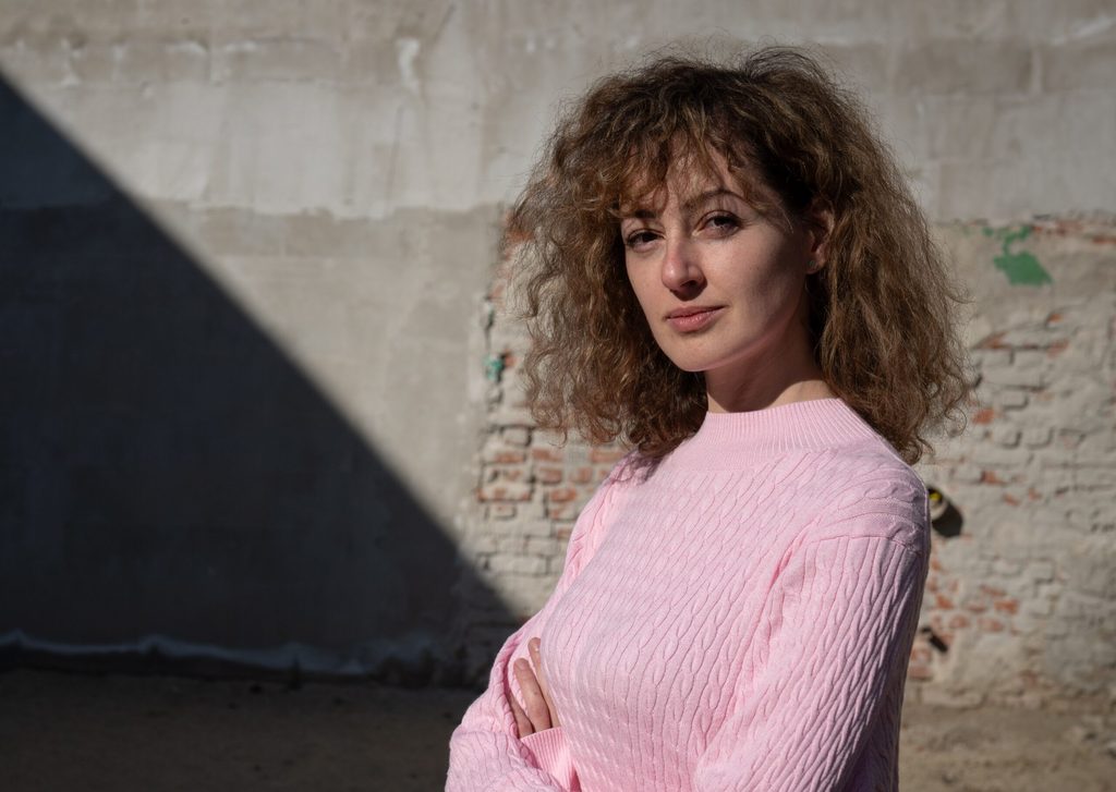 Irina, 32, is posing in front of the shelter in Bucharest, Romania