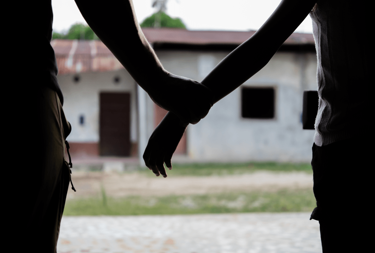 Manos de niña y adulto simulando unión forzada.