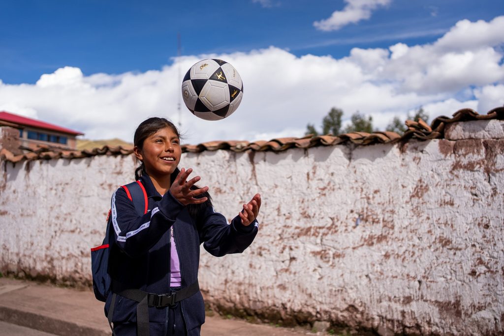 Shendy, participante del proyecto "Únete contra la discriminación" jugando fútbol en la región Acomayo, Cusco.