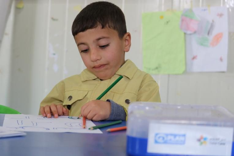 Ahmad learning at the Plan International-supported day care centre