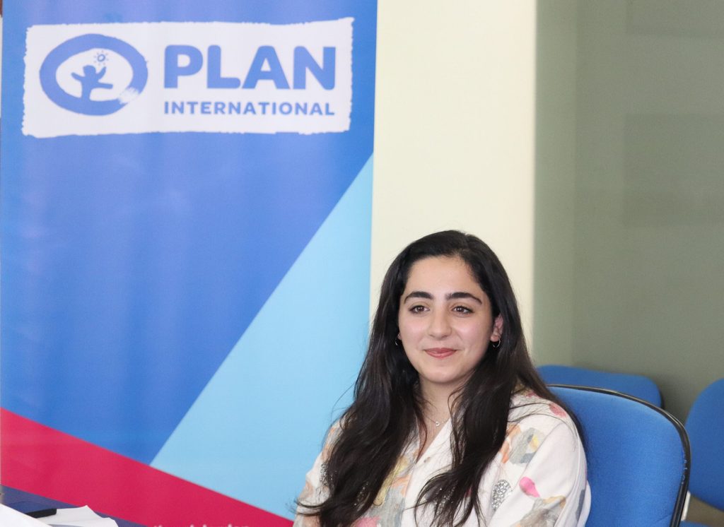A young woman attending a meeting