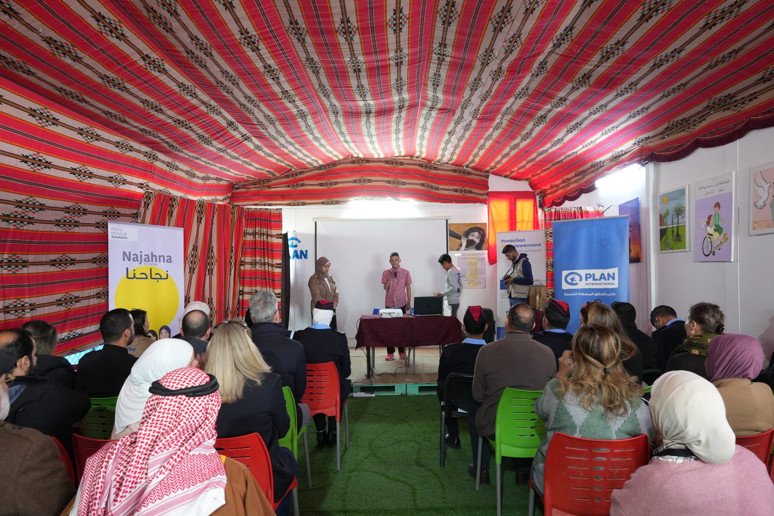 Group of youth performing on the stage in a refugee camp