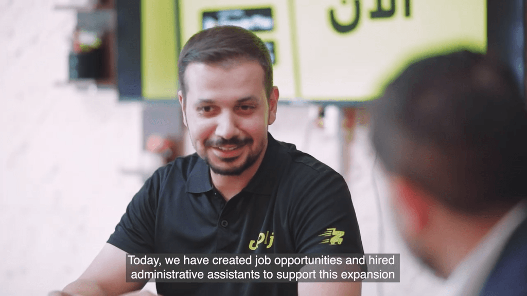 A screenshot for a man discussing in a meeting