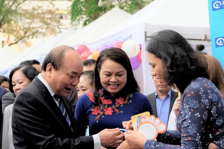 Prime Minister Nguyen Xuan Phuc visits Plan International Vietnam's booth