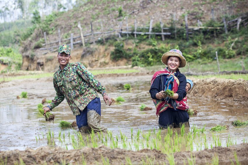 Yna, 20, and her husband A Don, 22, plant rice together in their paddy field