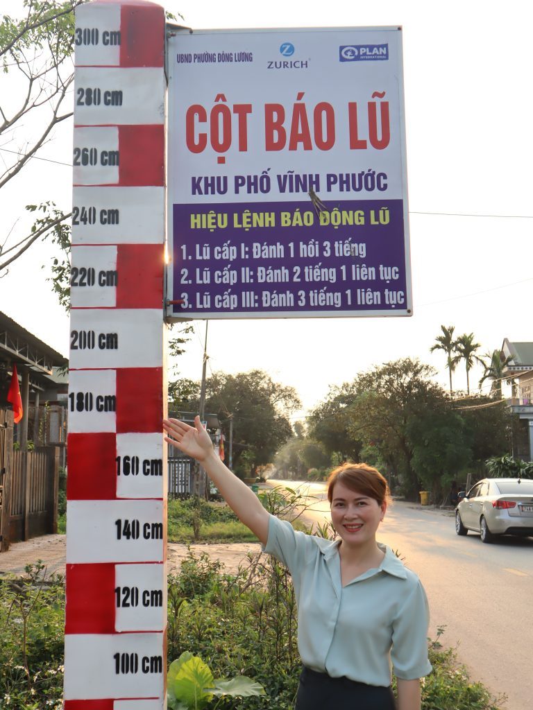 Ms. Lan Chi showing a way to monitor the level of flood in her community