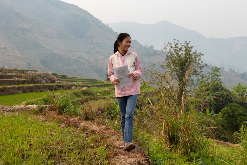 Huyen passing a paddy field