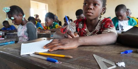 Diatou, an out-of-school girl takes a seat in the classroom