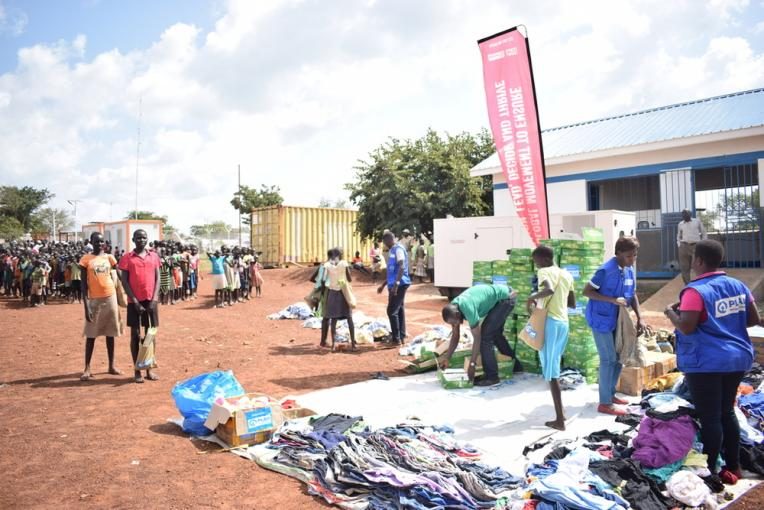 Children receiving critical relief items in Palabek refugee settlement