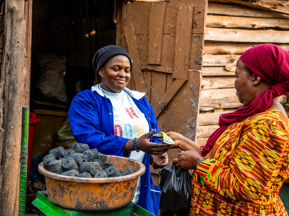 Fatuma taking payment for some briquettes. 