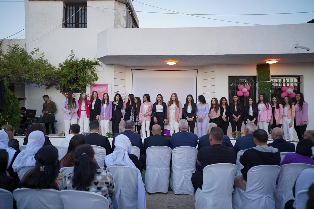 A group of girls and young women standing on stage.