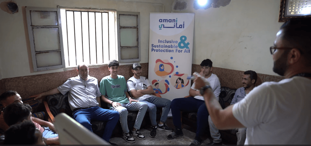 A group of young men and male caregivers attending a session