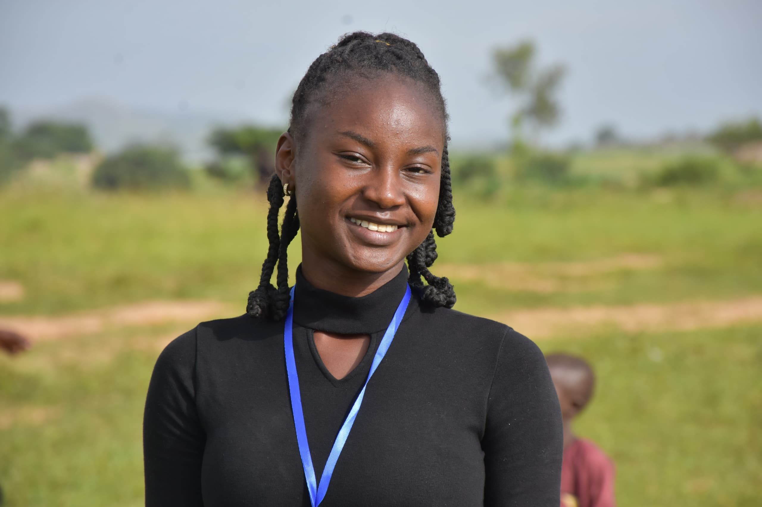A young woman smiling.