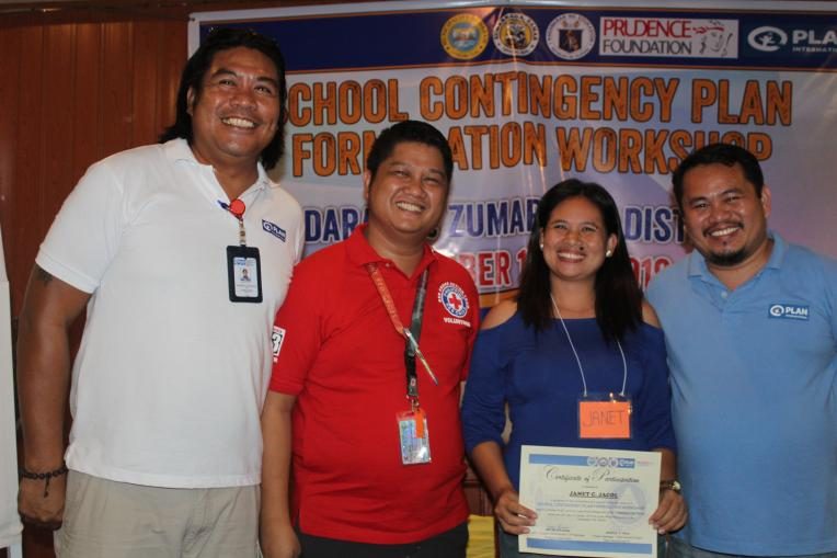 Janet receives her certificate of completion in the Contingency Planning Formation Workshop conducted by Plan International.