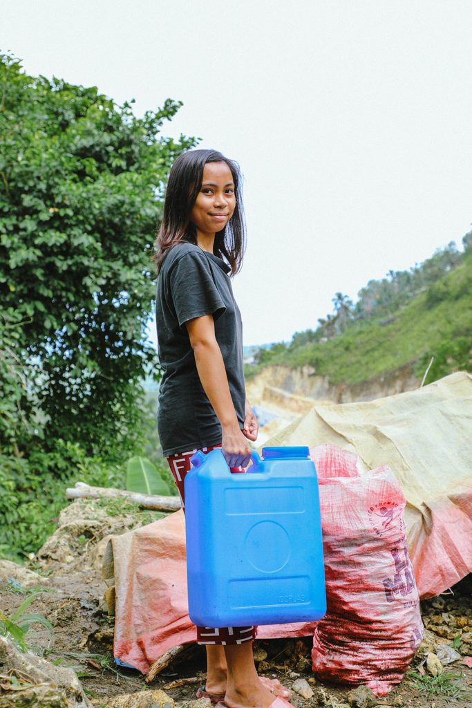 Bernadette preparing for the journey downhill to her community’s water source with one of the jerry cans included in the water kit 