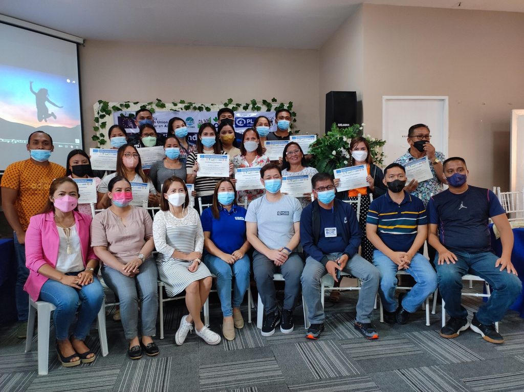 Educators hold up their Certificates of Participation after finishing the seminar 