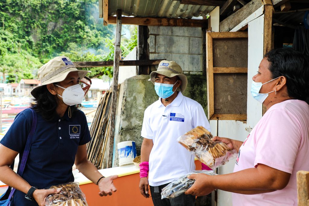 Marina shows her packaged dried squid to Arlynn Aquino from ECHO during a monitoring visit 