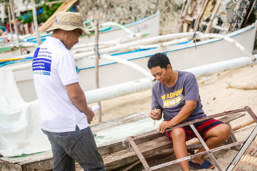 Marita, another livelihood beneficiary, weaves the netted frames where squid are placed to dry