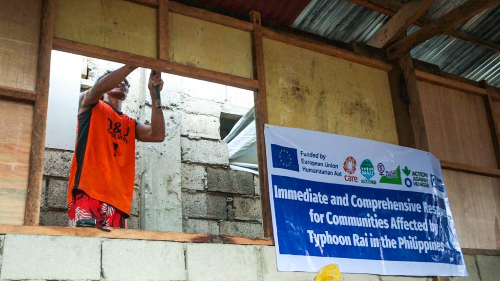 Jennifer’s husband, Reyland, repairing their house with the materials they received