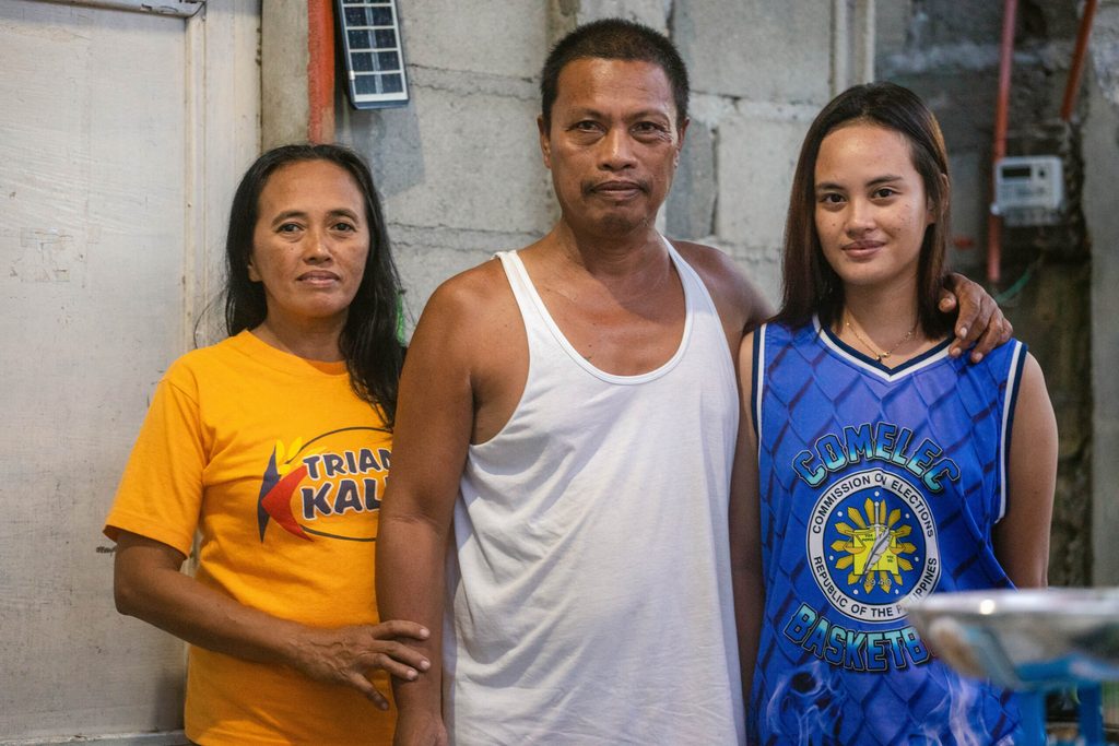 Mercedita and her husband Dominador, along with one of their children 