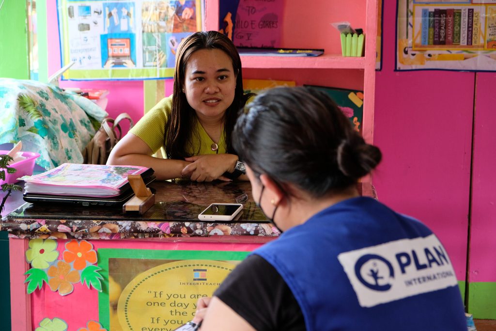 Teacher Dana being interviewed by Plan International staff