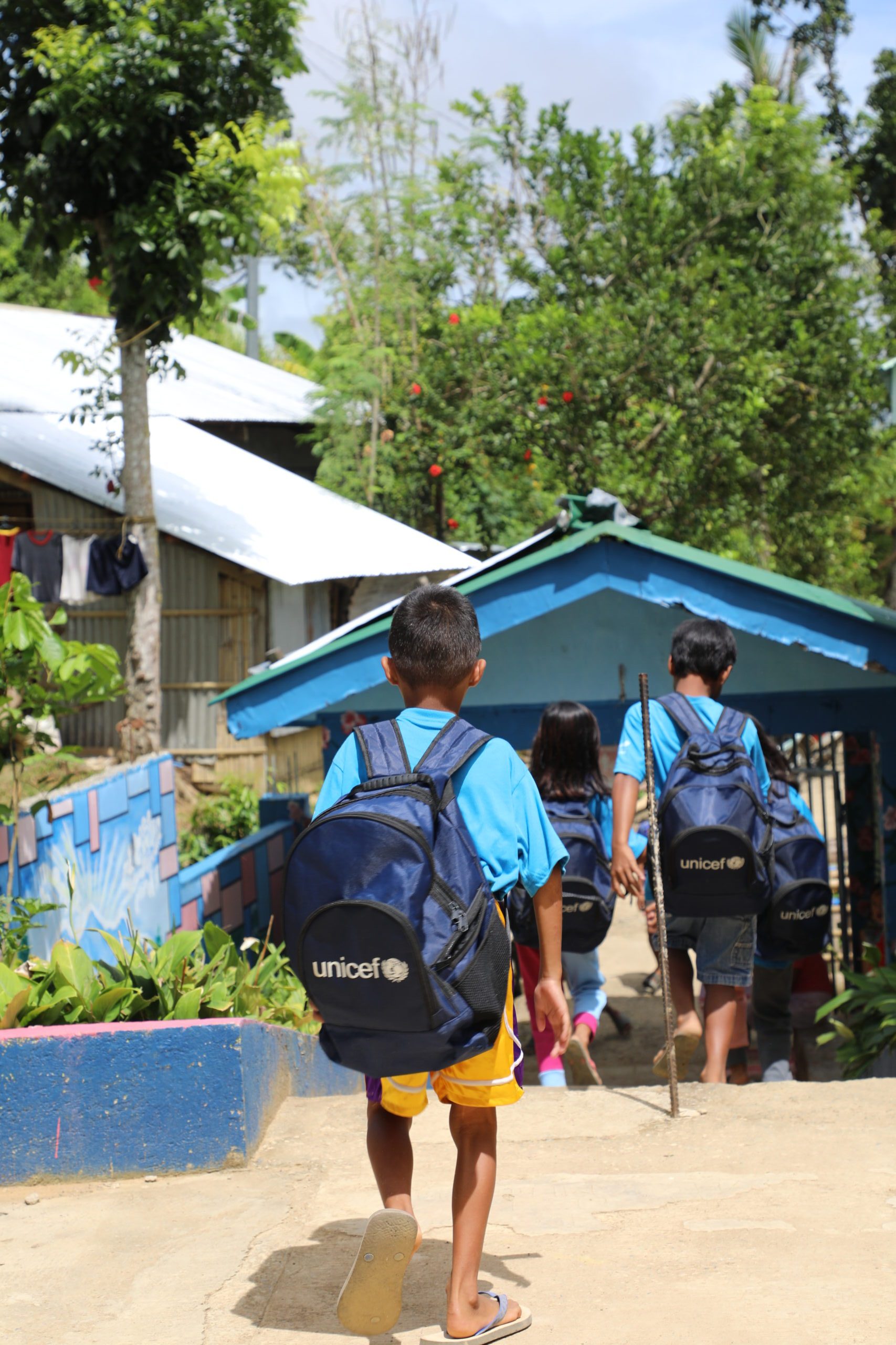 An elementary student headed back home with his UNICEF Learner Kit 