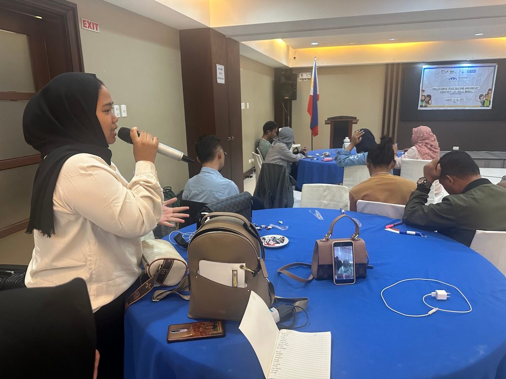 A youth participant speaks at the workshop