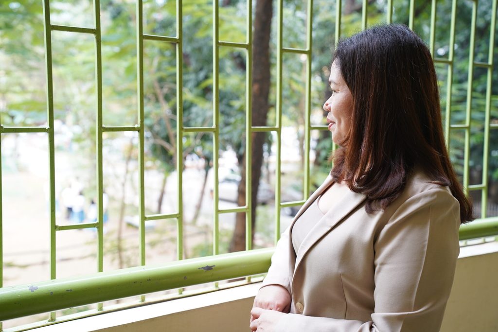 Woman looks to a school field