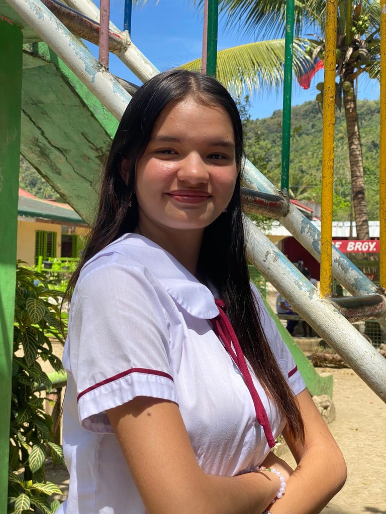 A girl in school uniform poses for a photo