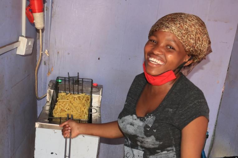 Grace at her stall with freshly made fries/chips.