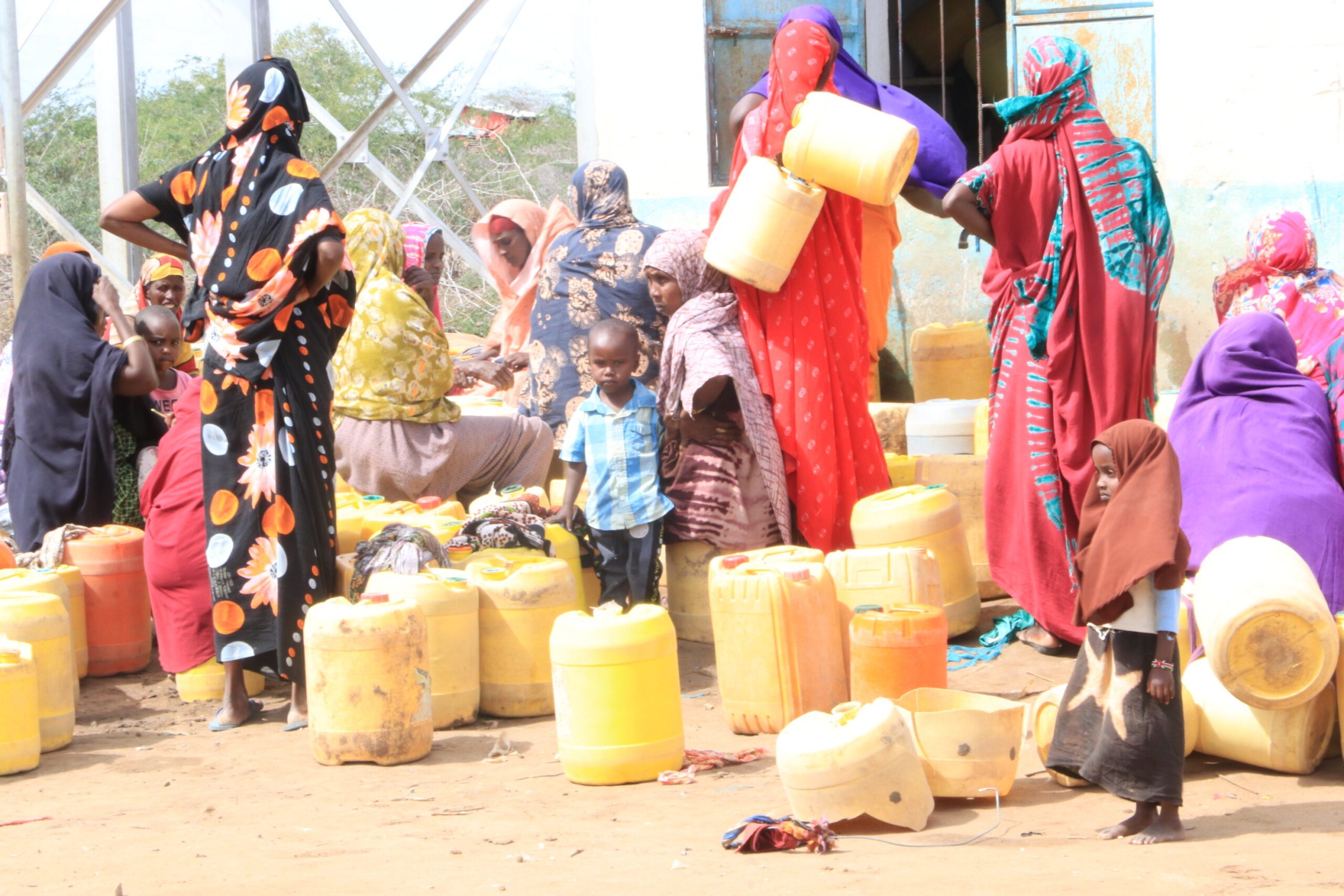 Girls and women waiting to collect water in Kenya