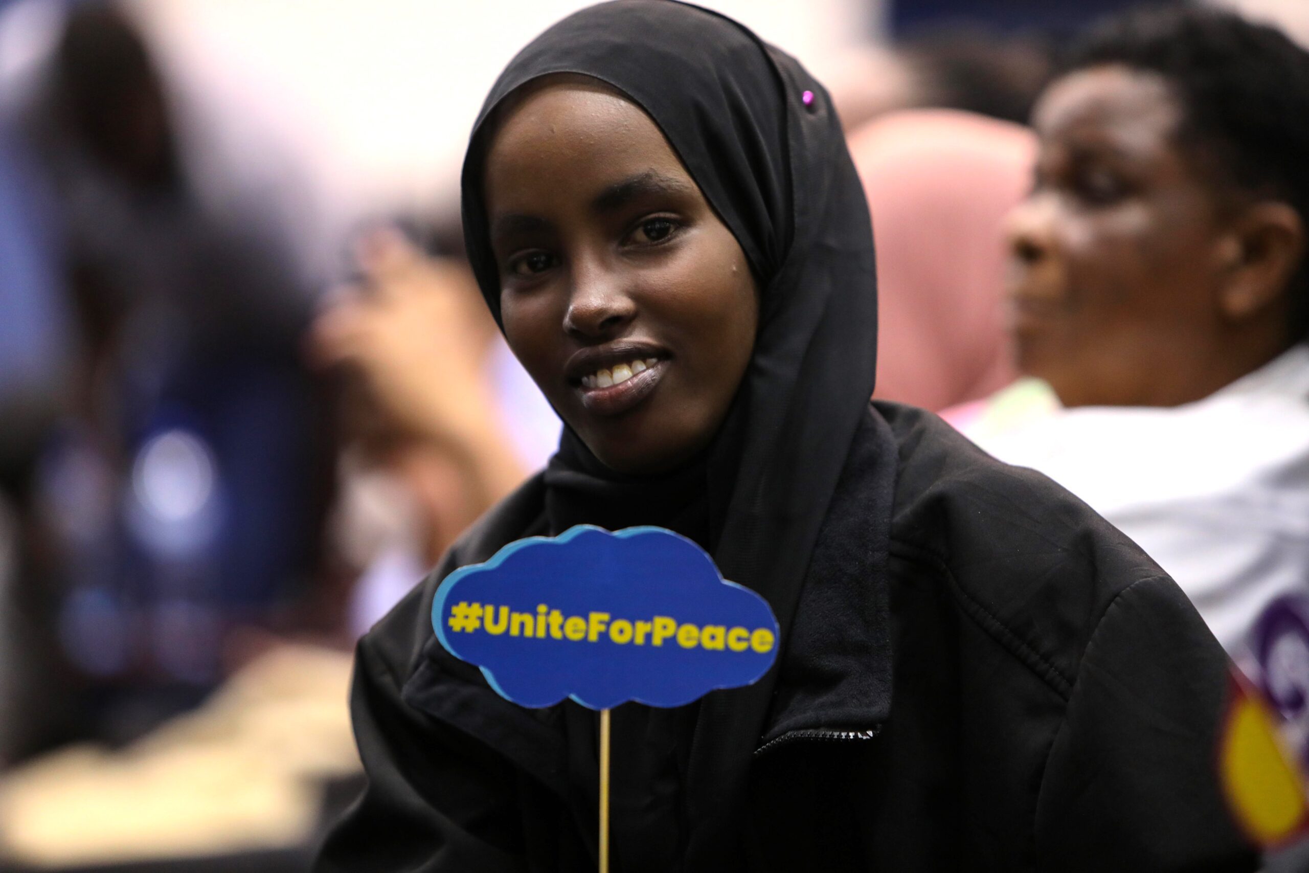 A girl advocate in Kenya holding a placard during the #UniteForPeace campaign.