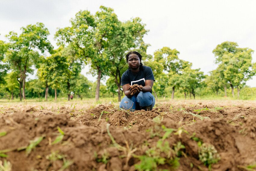 young female farmer examines crops