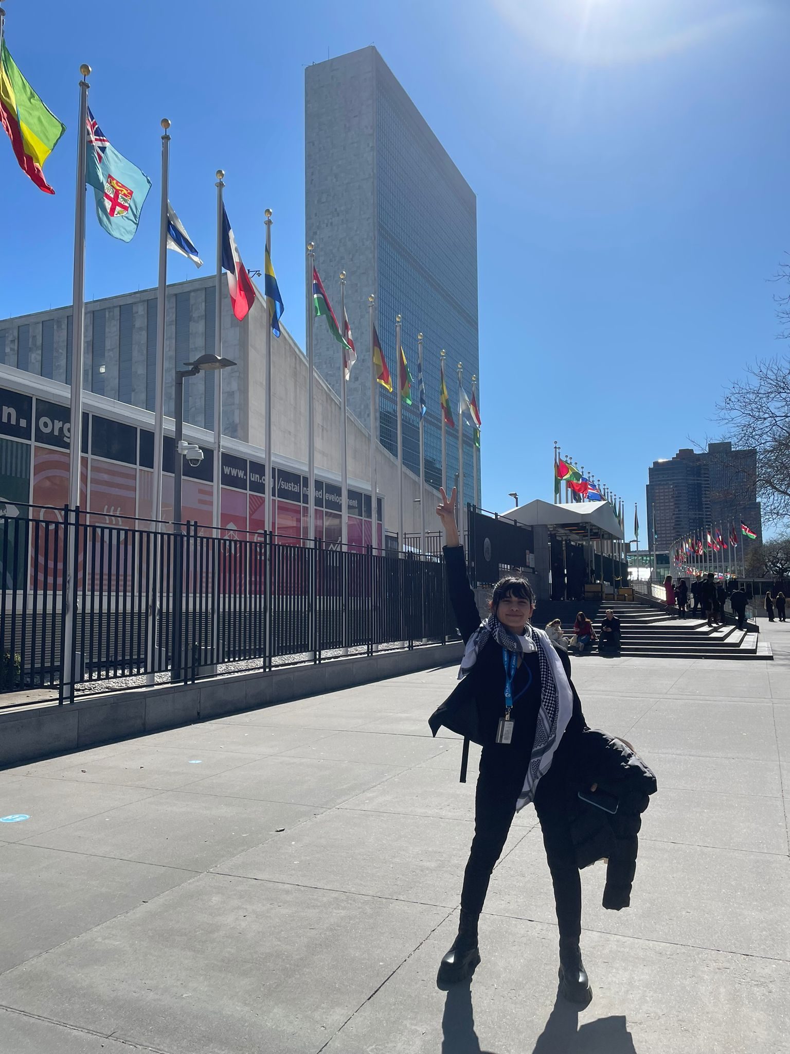 Youth Advocate Lilian poses in front of the UNHQ