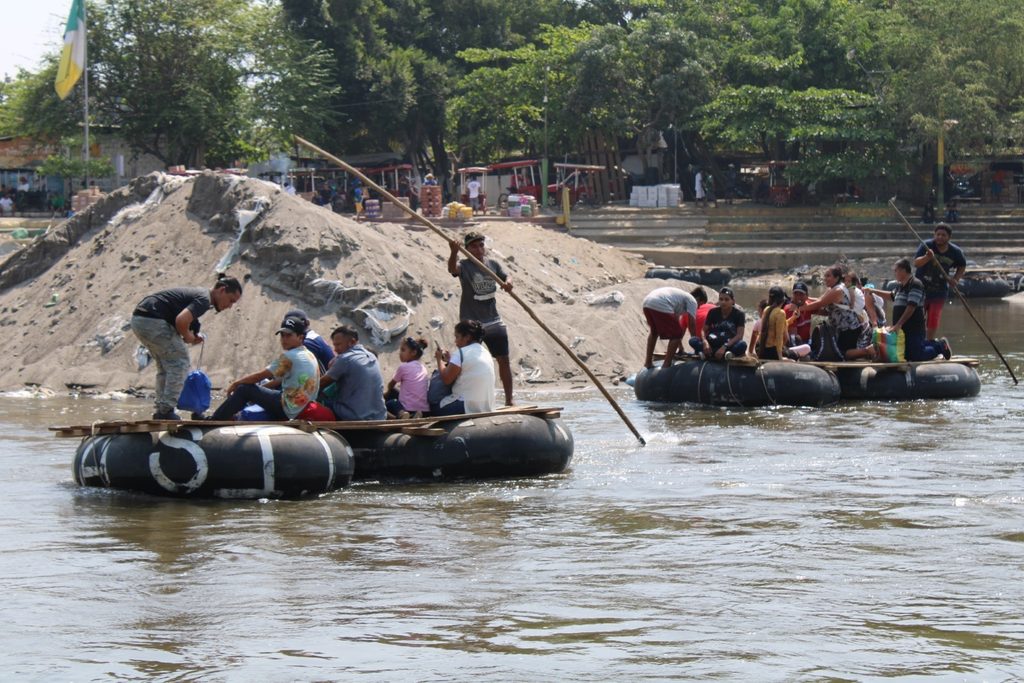 Families crossing the Suchiate River at the border between Guatemala and Mexico.