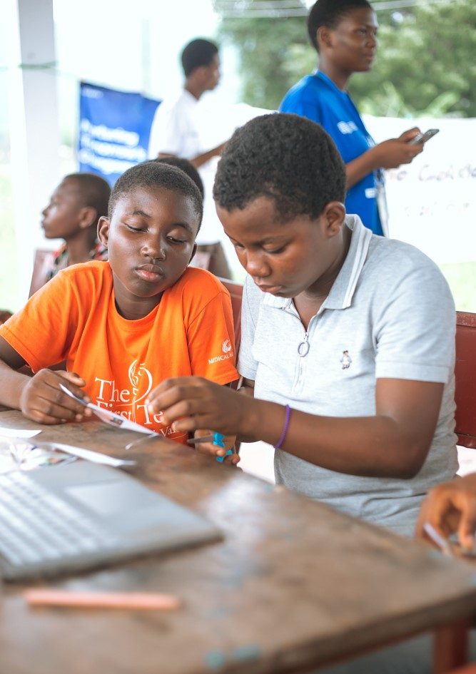 Girls from the Ayikuma community participate in a STEM activity at a Libraries Without Walls program.