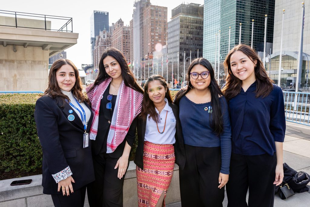 A group of 5 youth advocates pose at UN Headquarters