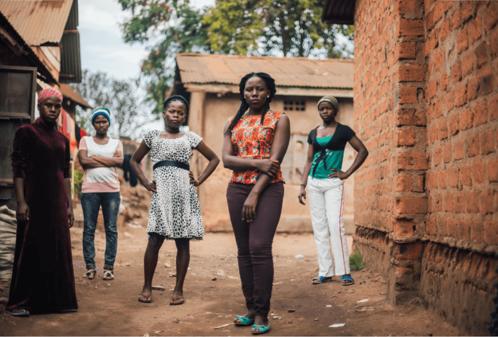 Women standing next to each other, looking at camera in a powerful way.