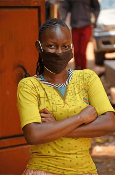 Woman wearing dace mask to prevent the spread of COVID-19, Uganda