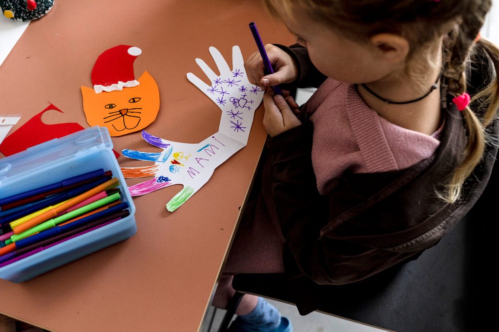 Girl drawing in a classroom in Poland.