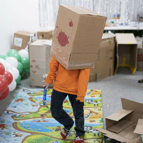 Boy plays with cardboard box at the Depaul centre in Kharkiv. 