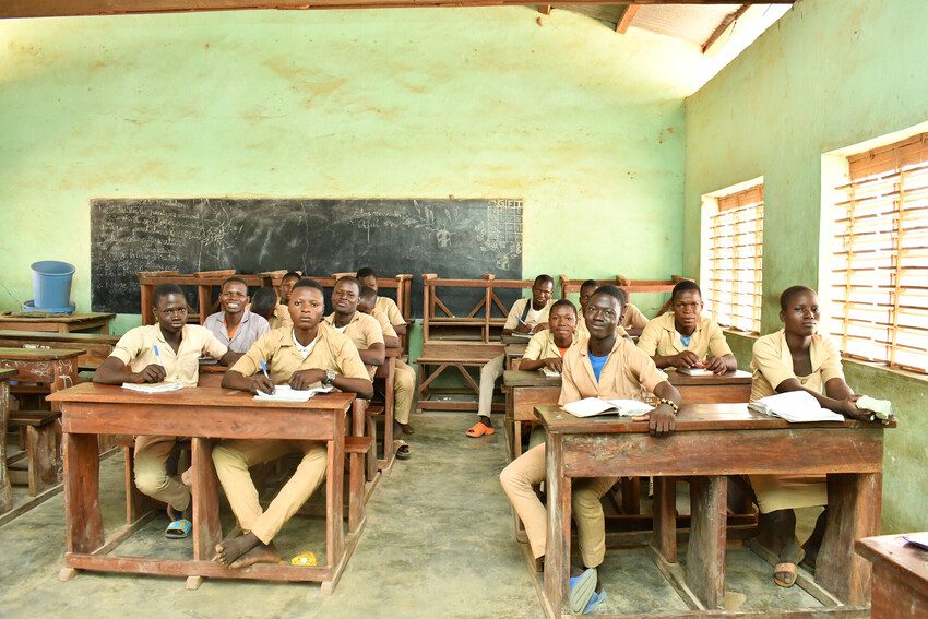 School children sat behind desks in a classroom, 