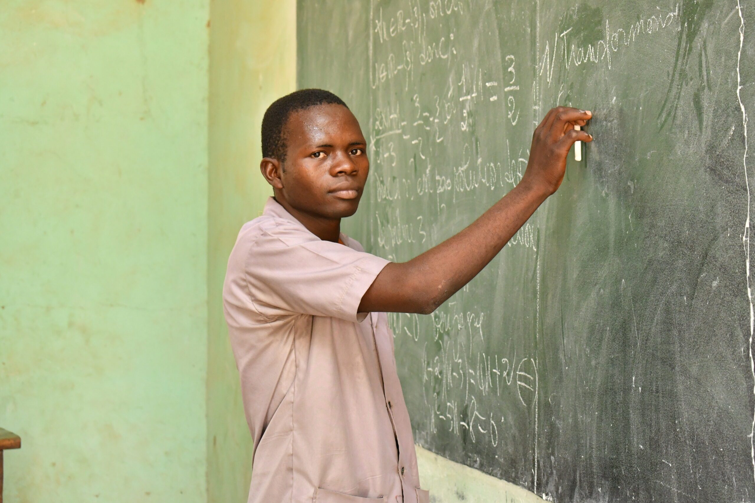 Pascal doing a mathematics exercise on the board.
