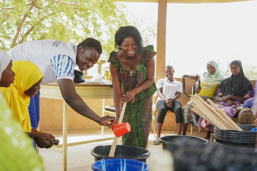 Youth leader Bernadette teaching girls how to produce soap