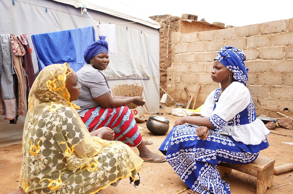Rihanata visiting her internally displaced neighbours living under a tent.