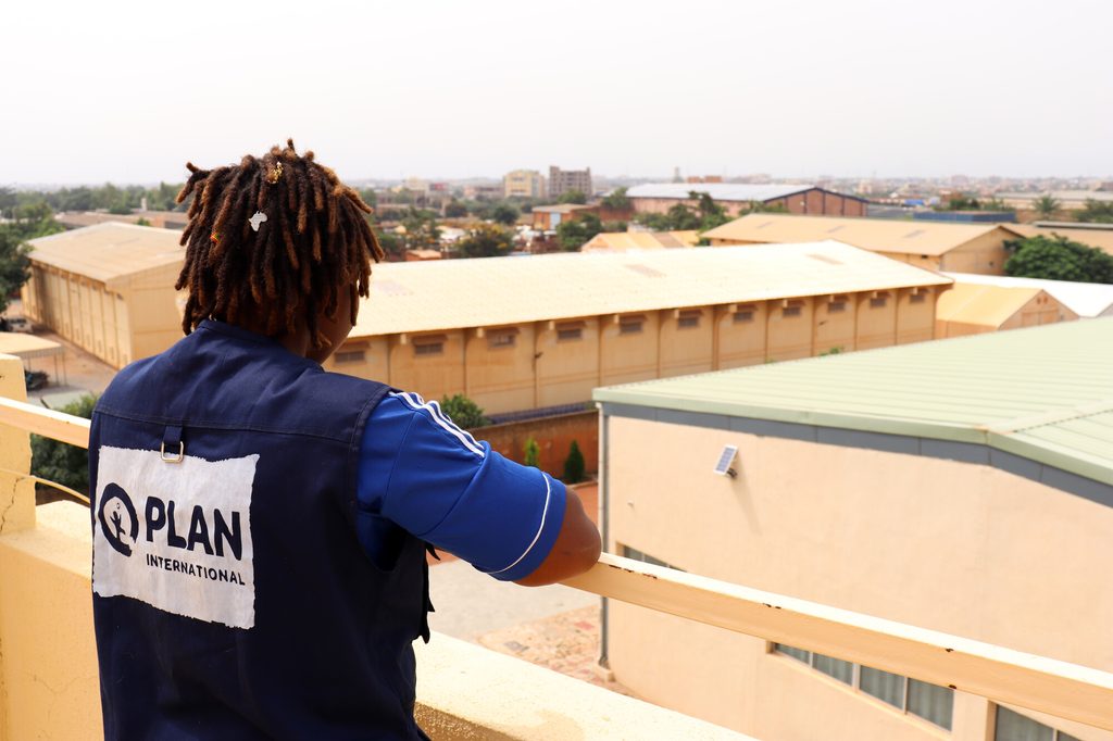 Cherifatou looks out at Ouagadougou from roof of Plan International Country Office. 