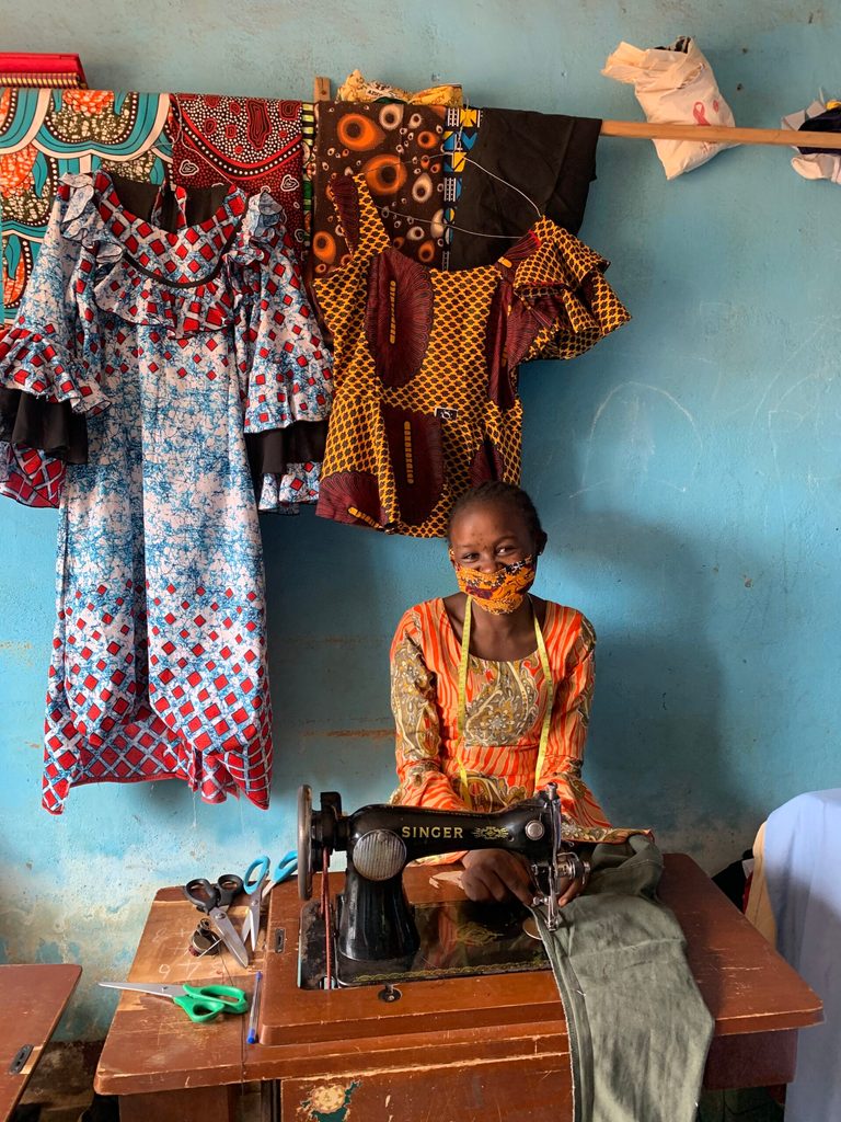 Theresia at the vocational training centre sewing an outfit