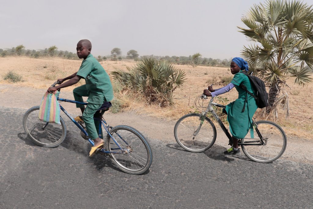 Boy and girl riding to school