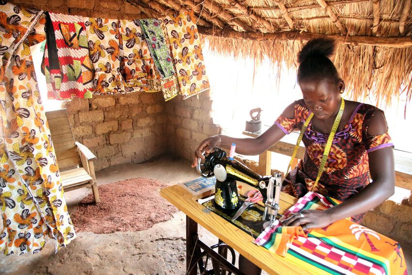 Gracia using her sewing machine.