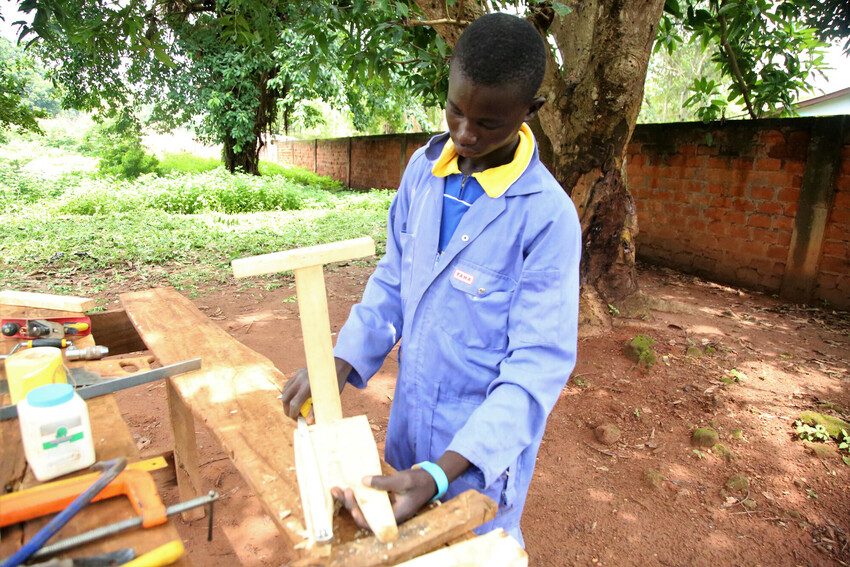 Junior uses his skills in carpentry.